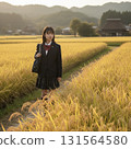High school girl walking through rice field 131564580
