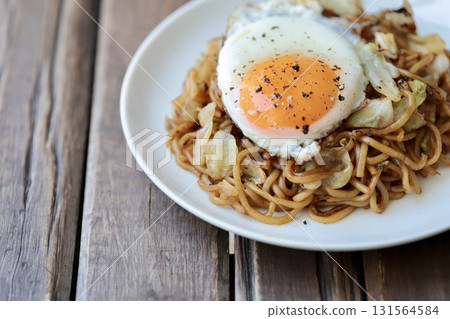 Medium-thick yakisoba noodles topped with a fried egg Medium-thick yakisoba noodles topped with a fried egg 131564584