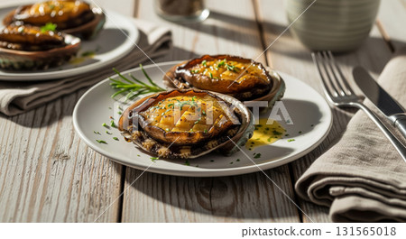 Butter Grilled Abalone with Herbs on White Plate 131565018