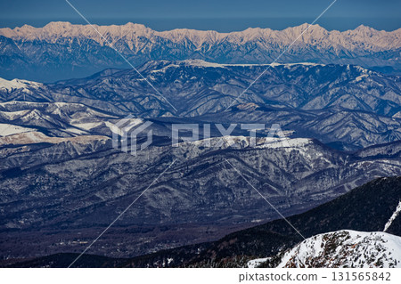 View of the Tateyama and Ushiro-Tateyama mountain ranges in winter from Yokodake in the Yatsugatake mountain range View of the Tateyama and Ushiro-Tateyama mountain ranges in winter from Yokodake in the Yatsugatake mountain range 131565842
