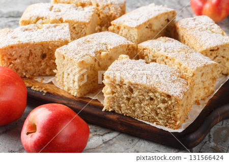 Delicious old fashioned applesauce cake with ginger and cinnamon close-up on wooden board. Horizontal 131566424
