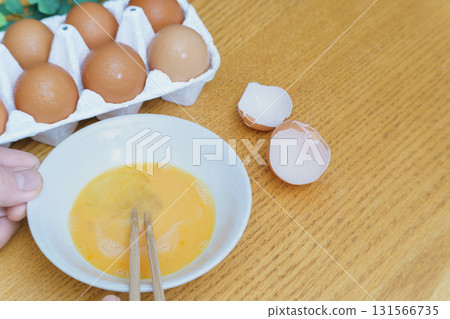 Break the raw egg and mix Break the raw egg and mix 131566735