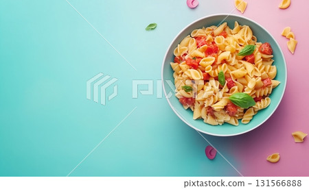 Macaroni pasta with topping tomato sauce and basil on bowl copy space blue background 131566888