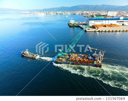 Aerial view of a barge and tugboat heading to a construction site at Hakodate Port in Hakodate, Hokkaido in autumn 131567069