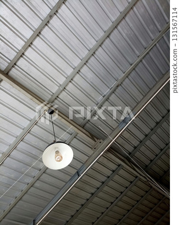 Industrial Metal Ceiling with Hanging White Light Fixture Industrial Metal Ceiling with Hanging White Light Fixture 131567114