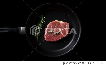 Red meat steak beef slice on black frying pan un cook with rosemary leaf 131567142