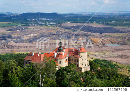 Jezeri Castle with Czechoslovak army coal mine in background, Horni Jiretin, Most district, Ustecky region, Czech Republic, sunny summer day 131567396