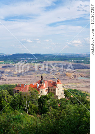 Jezeri Castle with Czechoslovak army coal mine in background, Horni Jiretin, Most district, Ustecky region, Czech Republic, sunny summer day 131567397