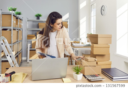 Female Entrepreneur Conducting Inventory In Warehouse Female Entrepreneur Conducting Inventory In Warehouse 131567599