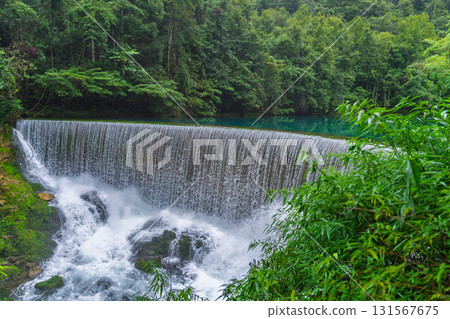 Waterfalls and streams among green mountains and clear waters in Guizhou Xiaoqikong Scenic Area 131567675