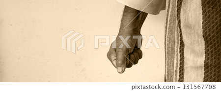 Man clenched his fist against a white wall 131567708
