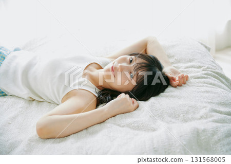 A woman lying on the bed 131568005