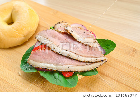 Duck roast pastrami on a bagel Duck roast pastrami on a bagel 131568077