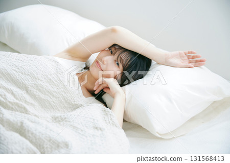 A woman lying in bed A woman lying in bed 131568413
