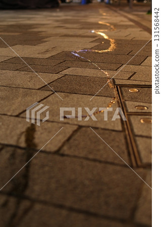 Water Trail on Night Pavement 131568442