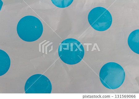 Wrinkled opaque plastic background with blue dotted pattern textured plastic surface close-up 131569066