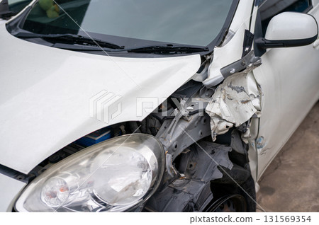 Severe front-end collision damage on compact car with internal structure exposed - automotive claim and digital repair assessment concept 131569354