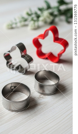 Colorful flower and bunny shaped cookie cutters on rustic wooden table 131569776