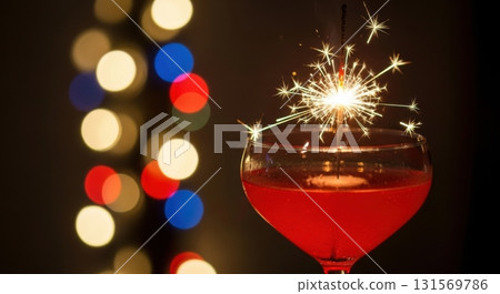 Festive sparkling cocktail with bokeh lights and sparkler celebration 131569786