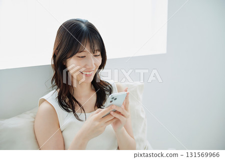一個操作智能手機的年輕女子 131569966