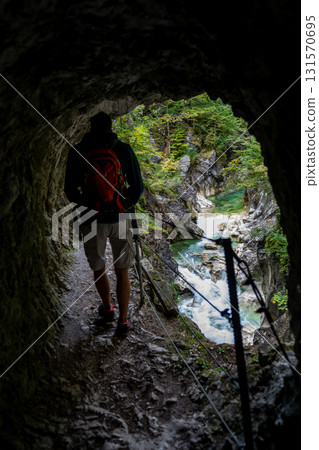 Hiker On Spectacular Hiking Trail Triftsteig Through Canyon Kaiserklamm With Brandenburger Ache In Tyrol, Austria 131570695
