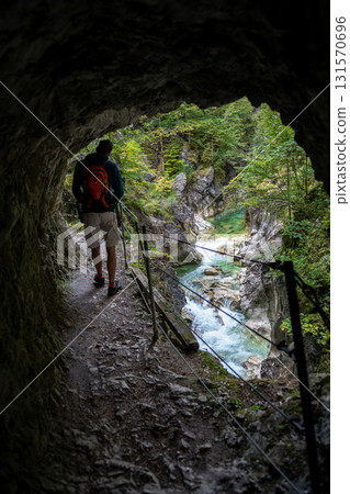 Hiker On Spectacular Hiking Trail Triftsteig Through Canyon Kaiserklamm With Brandenburger Ache In Tyrol, Austria 131570696