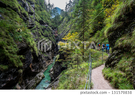 Hiking Group On Spectacular Trail Triftsteig Through Canyon Tiefenbachklamm With Brandenburger Ache In Tyrol, Austria Hiking Group On Spectacular Trail Triftsteig Through Canyon Tiefenbachklamm With Brandenburger Ache In Tyrol, Austria 131570838