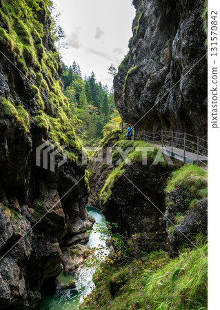 Hiking Group On Spectacular Trail Triftsteig Through Canyon Tiefenbachklamm With Brandenburger Ache In Tyrol, Austria 131570842