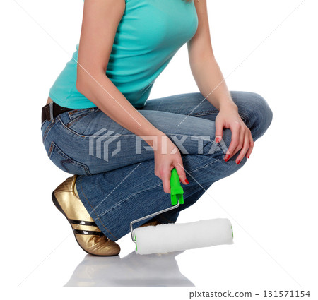woman with a roller brush against the white background. woman with a roller brush against the white background. 131571154