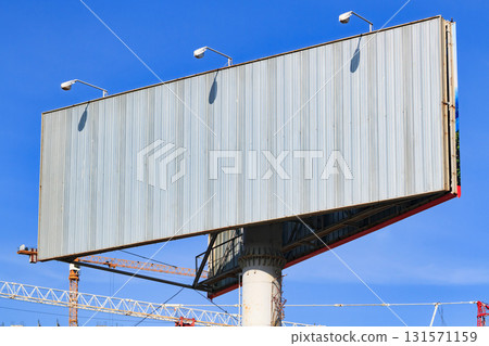 Large blank billboard with blue sky behind it. Large blank billboard with blue sky behind it. 131571159