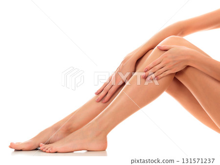 Beautiful smooth and shaved woman's legs. Isolated on white background. Skincare treatment concept Beautiful smooth and shaved woman's legs. Isolated on white background. Skincare treatment concept 131571237
