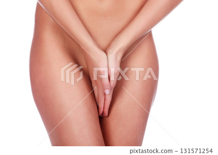 Closeup shot of woman holding her hands between the legs, isolated on white background 131571254