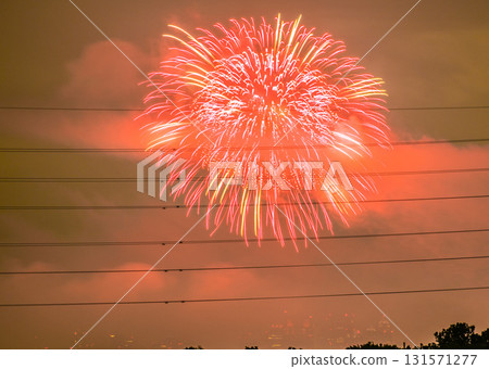 Tokyo cityscape in Japan, Tamagawa Fireworks Festival 2025. The venue side of the 47th Setagaya Ward Tamagawa Fireworks Festival, with the Tokyo Metropolitan Government Building in Shinjuku in the background. 131571277