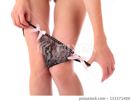 Closeup shot of woman pulling down her panties, isolated on white background Closeup shot of woman pulling down her panties, isolated on white background 131571489