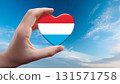 Luxembourg flag heart shape and blue sky 131571758