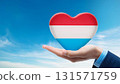 Luxembourg flag heart shape and blue sky 131571759