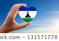 Lesotho flag heart and blue sky held by hand 131571778