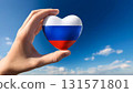 Hand holding a Russian flag heart and blue sky 131571801