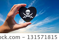Pirate flag heart and blue sky held in hand 131571815