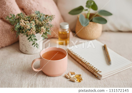 Omega-3 Capsules with Notebook and Cup of Tea 131572145
