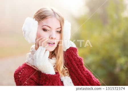Portrait of pretty gorgeous woman in earmuffs. 131572374