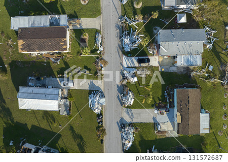 Consequences of natural disaster in Florida, USA. Aerial view of heavily damaged by hurricane Ian houses in mobile home residential area 131572687