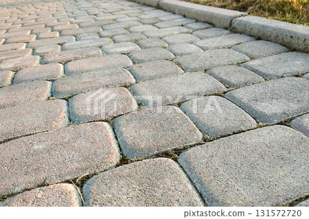 Close-up of slab stone paved path way at park or backyard. Walkway footpath road at house yard garden. Close-up of slab stone paved path way at park or backyard. Walkway footpath road at house yard garden. 131572720