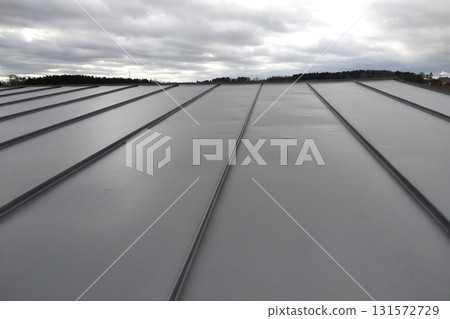 Close-up detail of house roof made from gray metal sheets. 131572729