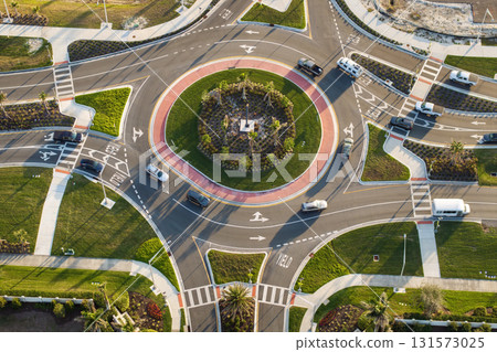 City street roundabout crossroads in Florida. Traffic infrastructure in USA. Road traffic circle intersection with driving cars 131573025