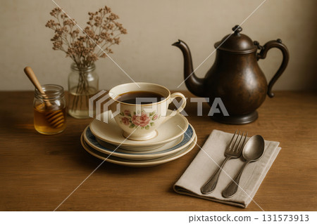 Vintage tea-time still life with floral teacup and teapot 131573913