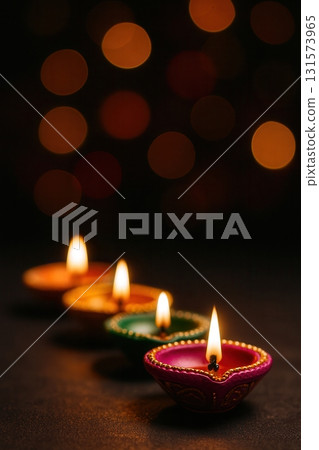 Colorful Row of Diwali Diyas with Glowing Flames and Bokeh Lights 131573965
