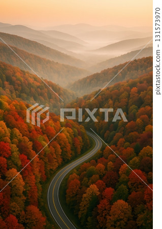 Autumn Forest with Winding Road and Misty Mountain Valley 131573970