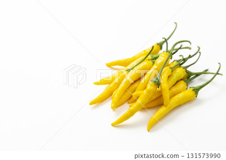 Yellow chili peppers on white background Yellow chili peppers on white background 131573990
