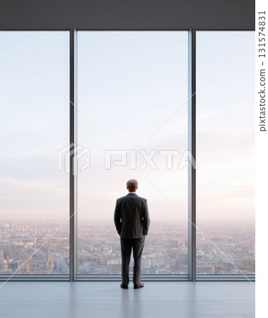 Pensive businessman standing alone in modern high rise office, looking out large window at city. powerful symbol of success, corporate ambition, and future vision Pensive businessman standing alone in modern high rise office, looking out large window at city. powerful symbol of success, corporate ambition, and future vision 131574831